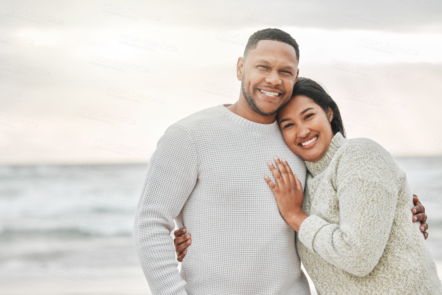 Buy stock photo Portrait, happy and couple hug on beach for travel date, romance vacation and bonding of destination peace. Woman, man and embrace with support of healthy relationship, commitment and ocean holiday
