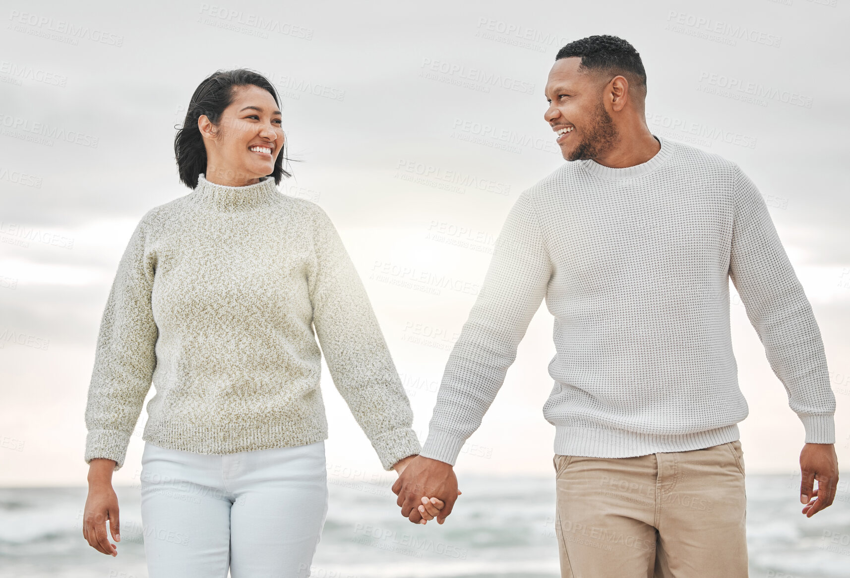 Buy stock photo Holding hands, smile and couple walking on beach in morning together for holiday, romance or travel. Date, love or vacation with happy man and woman on tropical island paradise for honeymoon trip