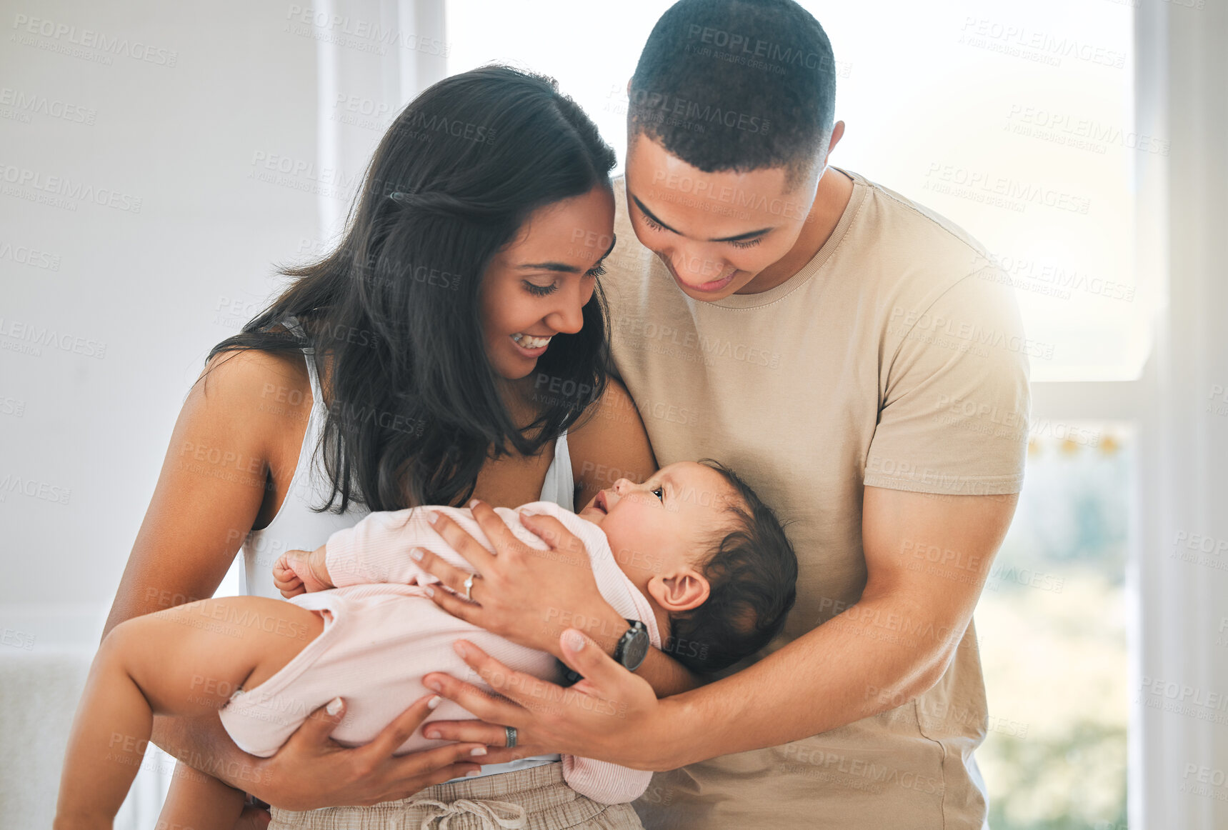 Buy stock photo Mother, father and holding baby in a family home for bonding, security and quality time. Happy woman, man and girl child relax together in a house for development, trust and support or care and love