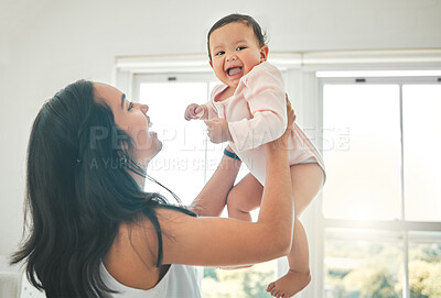 Buy stock photo Funny, mother and lifting baby, care and bonding together with infant in home. Smile, mama and raise newborn, child or kid, playing and having fun, happiness or enjoying quality time with family love
