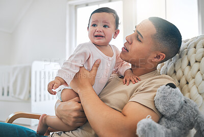 Buy stock photo Father, holding baby and crying in a family home while hungry, tired or sad. Frustrated and confused man or dad and girl child cry on a sofa while sick, colic or sleepy on a living room couch