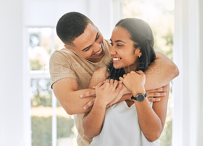 Buy stock photo Couple, hug and smile in home for love, care and relax for romance, support and trust of bond together. Happy man, woman and hugging partner for quality time, happiness and commitment to relationship