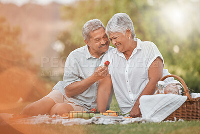 Buy stock photo Shot of a mature man feeding his wife a strawberry