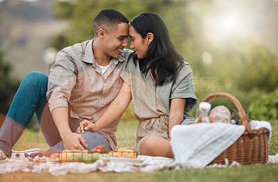 Buy stock photo Shot of a young couple enjoying a picnic together