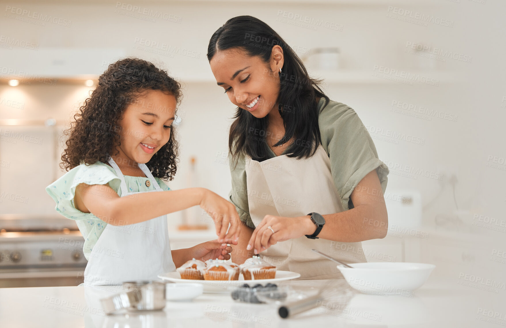 Buy stock photo Baking, cupcake and mom with child in kitchen with icing for cake, treats and dessert for bonding relationship. Family, home and mother and girl with ingredients, recipe and learning for fun together