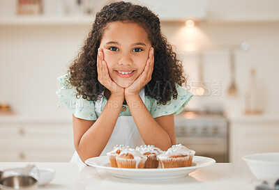 Buy stock photo Shot of a little girl patiently waiting to eat the freshly baked cupcakes