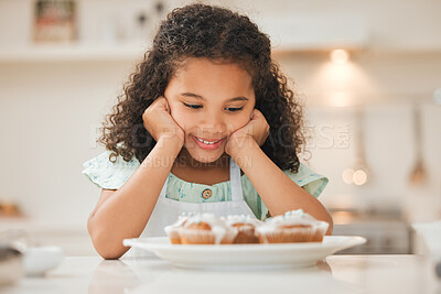Buy stock photo Shot of a little girl patiently waiting to eat the freshly baked cupcakes