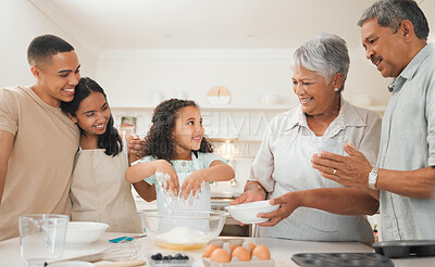 Buy stock photo Shot of three generations of a family baking together
