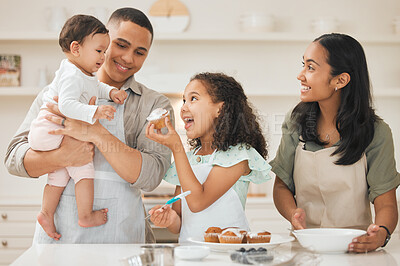 Buy stock photo Shot of a young family baking together