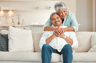 Buy stock photo Senior couple, couch and portrait with hug, smile and love in home living room with care, romance or happiness. Elderly man, old woman and embrace by lounge sofa in relax retirement together in house