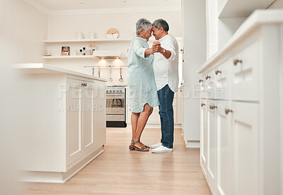 Buy stock photo Dancing, love and senior couple in kitchen, smile and bonding of old man and woman in anniversary. Lounge, sofa and embrace of elderly people with commitment to marriage, care and support in house