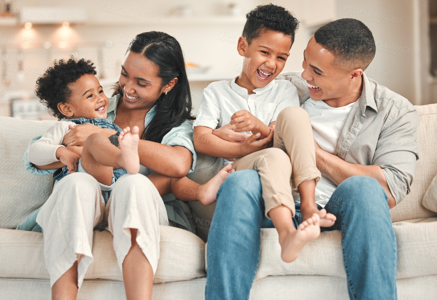 Buy stock photo Parents, kids and laugh in home at living room on portrait for fun, support and care. People, family and happy on sofa for bonding with siblings for childcare or child development on break and relax