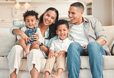 Buy stock photo Shot of a young family happily bonding together on the sofa at home