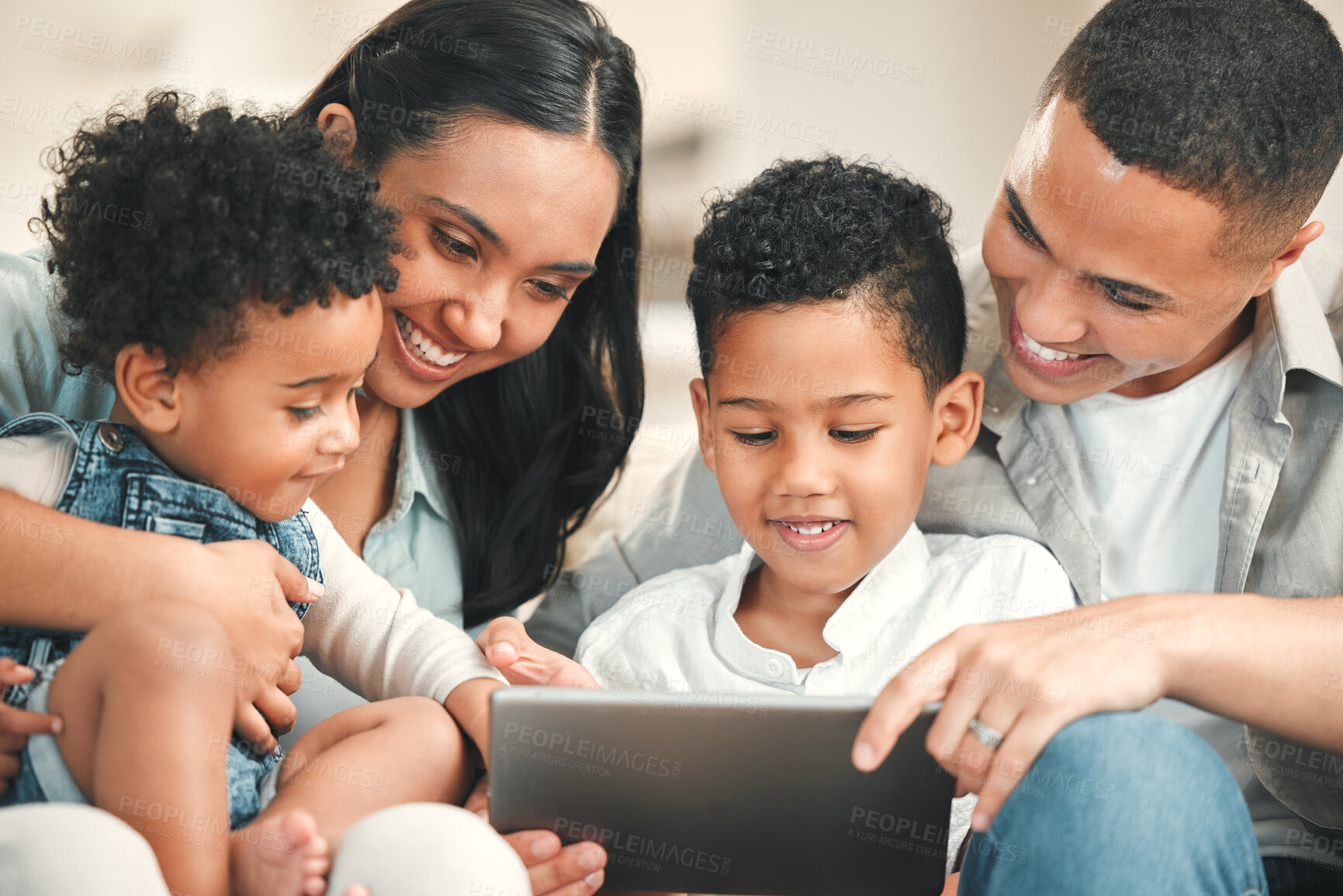 Buy stock photo Young happy family, kids and tablet on couch for game, movie or learning together in home, love and bonding. Parents, education and children on living room sofa with smile, care or app on touchscreen