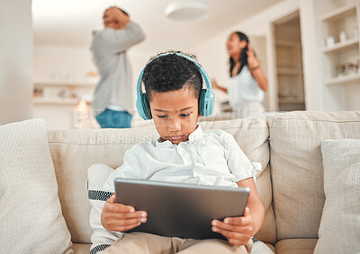 Buy stock photo Boy, headphones and parents fighting in house, tablet and streaming cartoons and online shows for distraction. Mental health, people and marriage conflict with kid on sofa, family break up and home