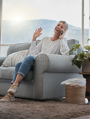 Buy stock photo Full length shot of an attractive senior woman making a phonecall while relaxing in her living room at home