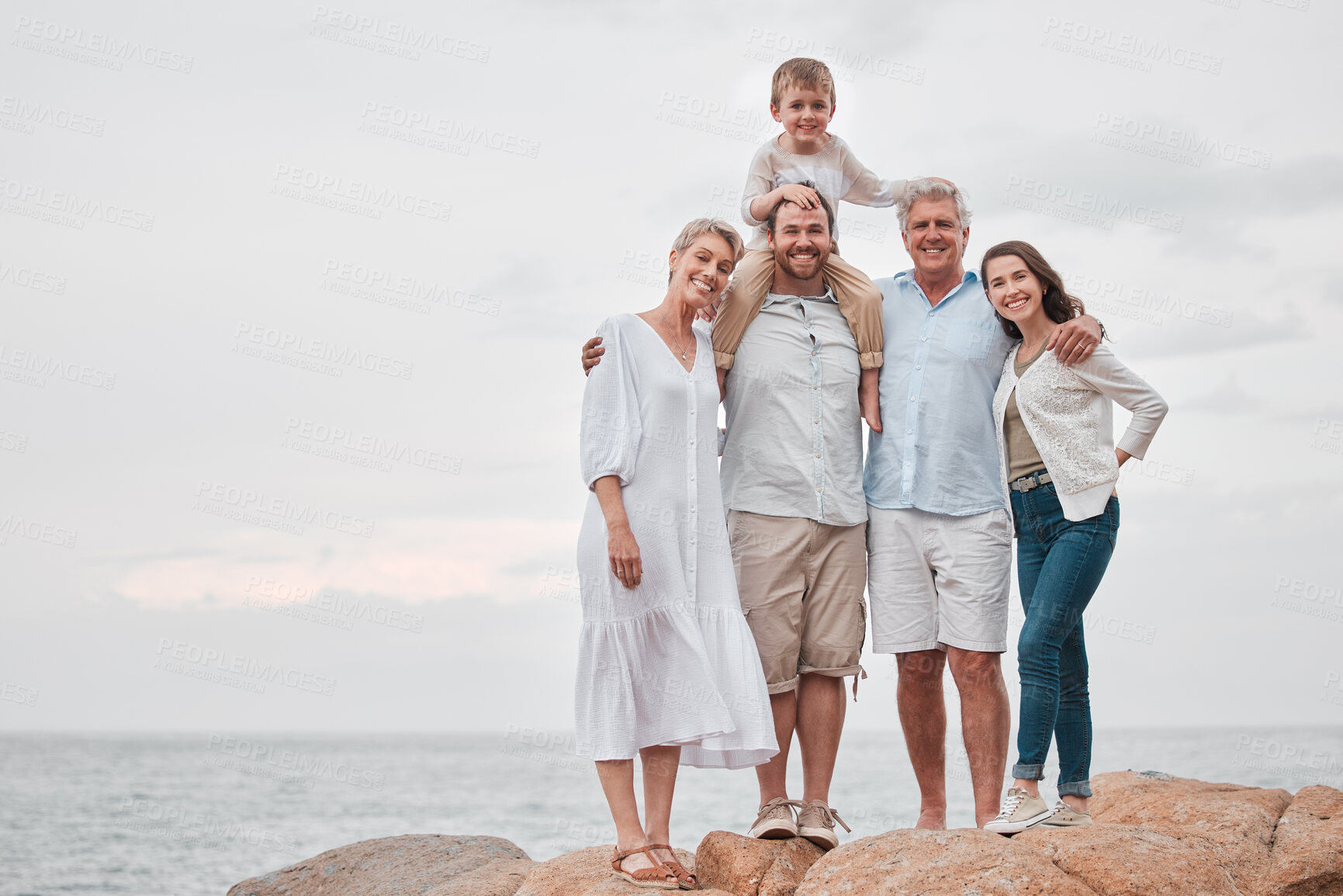 Buy stock photo Family, portrait and love for bonding, travel and vacation together in Santorini with ocean view. People, happy and adventure outdoor for relationship, holiday or retirement on mountain with smile