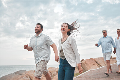 Buy stock photo Shot of a happy family enjoying a day along the coast