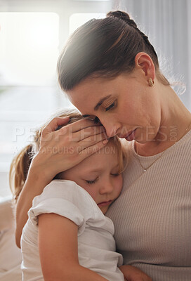 Buy stock photo Shot of a little girl feeling ill in bed at home and being comforted by her mother