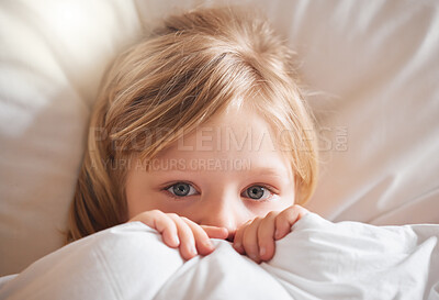 Buy stock photo Shot of a little girl feeling ill in bed at home and covering with a blanket