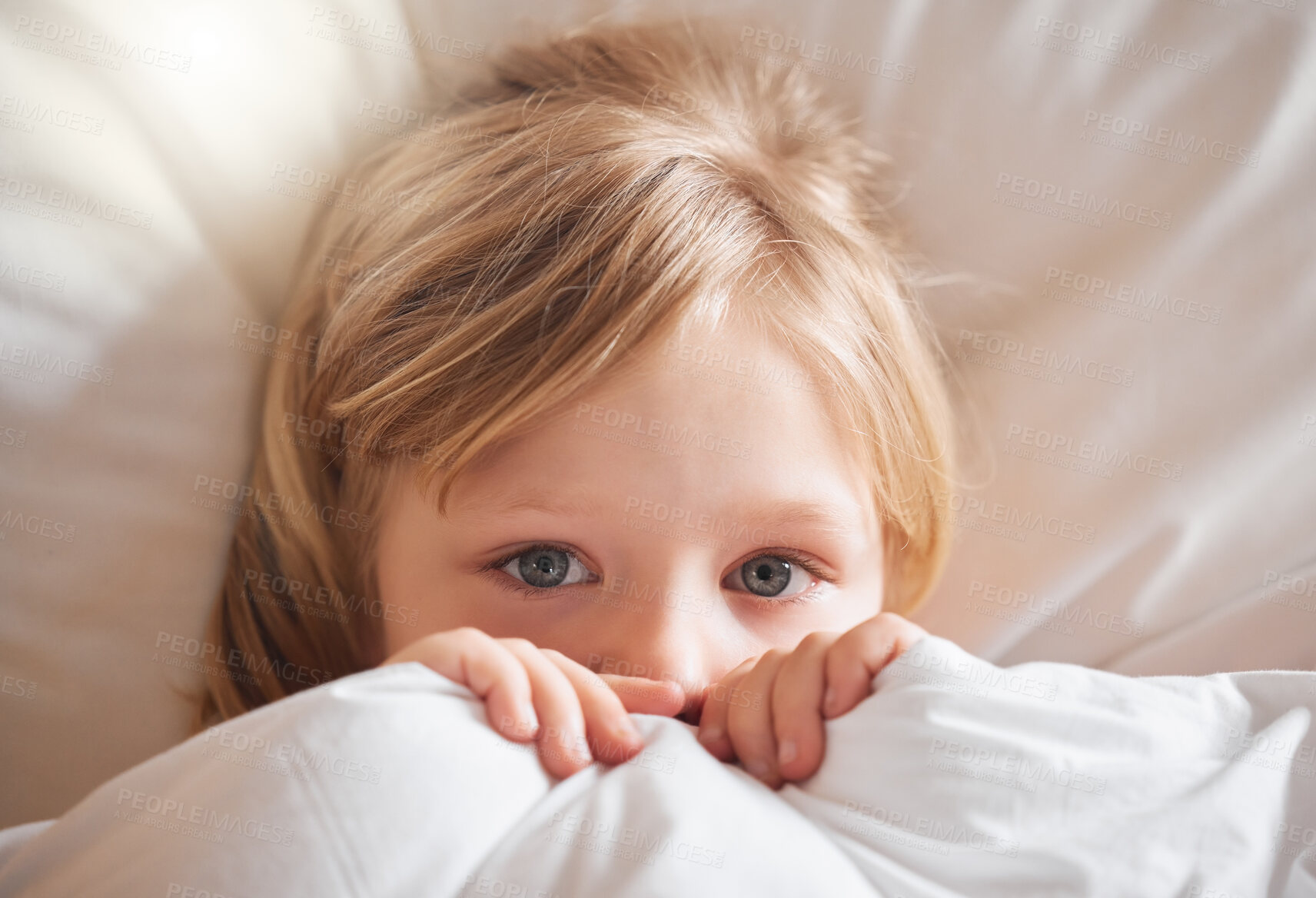 Buy stock photo Shot of a little girl feeling ill in bed at home and covering with a blanket