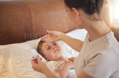 Buy stock photo Shot of a woman taking her little boy's temperature with a thermometer in bed at home