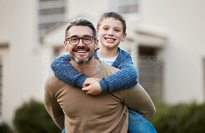 Buy stock photo Shot of a father giving his son a piggyback ride
