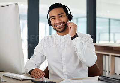 Buy stock photo Shot of a handsome young businessman working in a call center