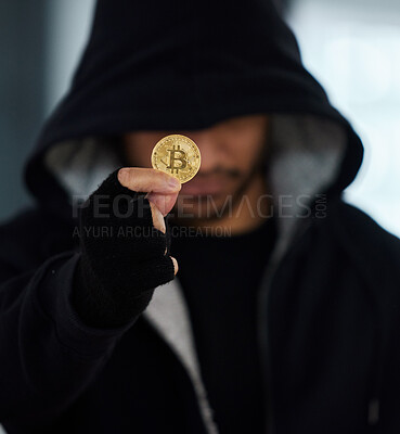 Buy stock photo Shot of a scammer holding a bitcoin