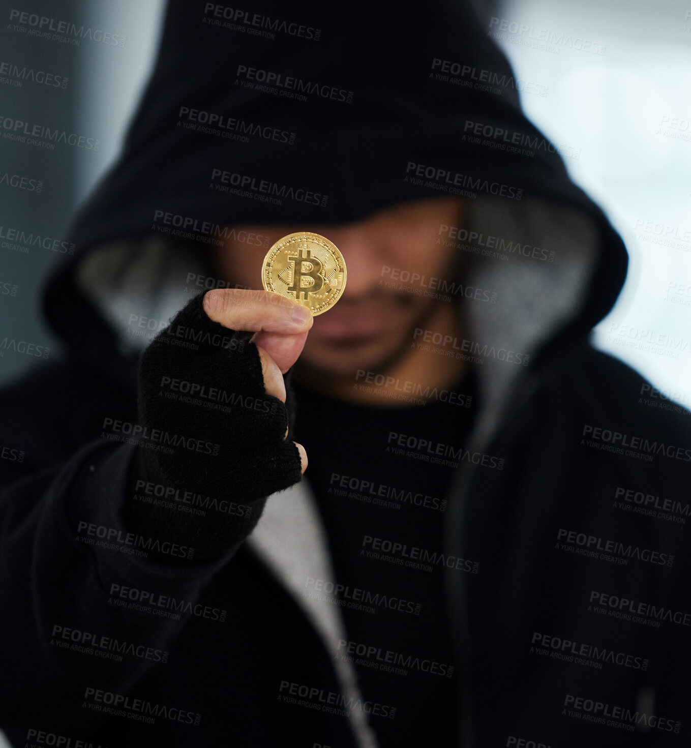 Buy stock photo Shot of a scammer holding a bitcoin