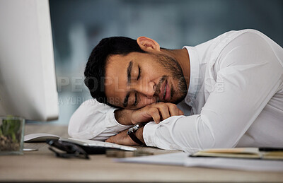 Buy stock photo Shot of a young businessman taking a nap at work