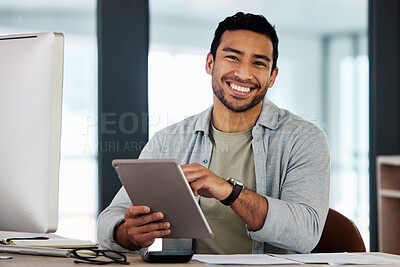 Buy stock photo Shot of a young businessman using his digital tablet
