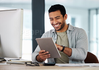 Buy stock photo Shot of a young businessman using his digital tablet