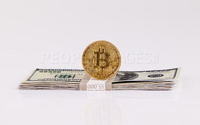 Buy stock photo Shot of a coin and a wad of cash against a grey background