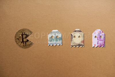 Buy stock photo Studio shot of bitcoin pacman chasing the money alines against a brown background
