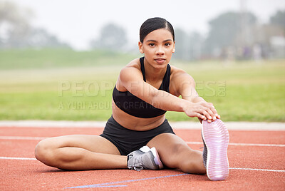 Buy stock photo Full length portrait of an attractive young female athlete going through her warmups out on the track