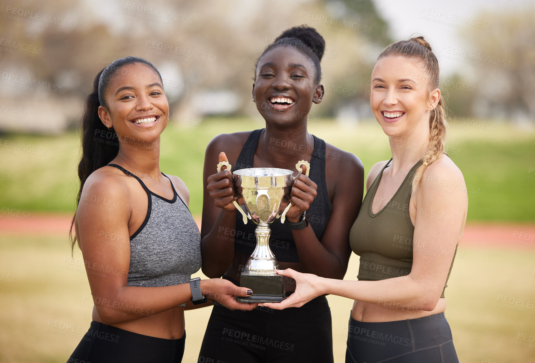 Buy stock photo Women, trophy and celebration with award as athlete for win, competition and sport achievement outdoor. Team, portrait and success with professional running, prize and  podium performance as champion