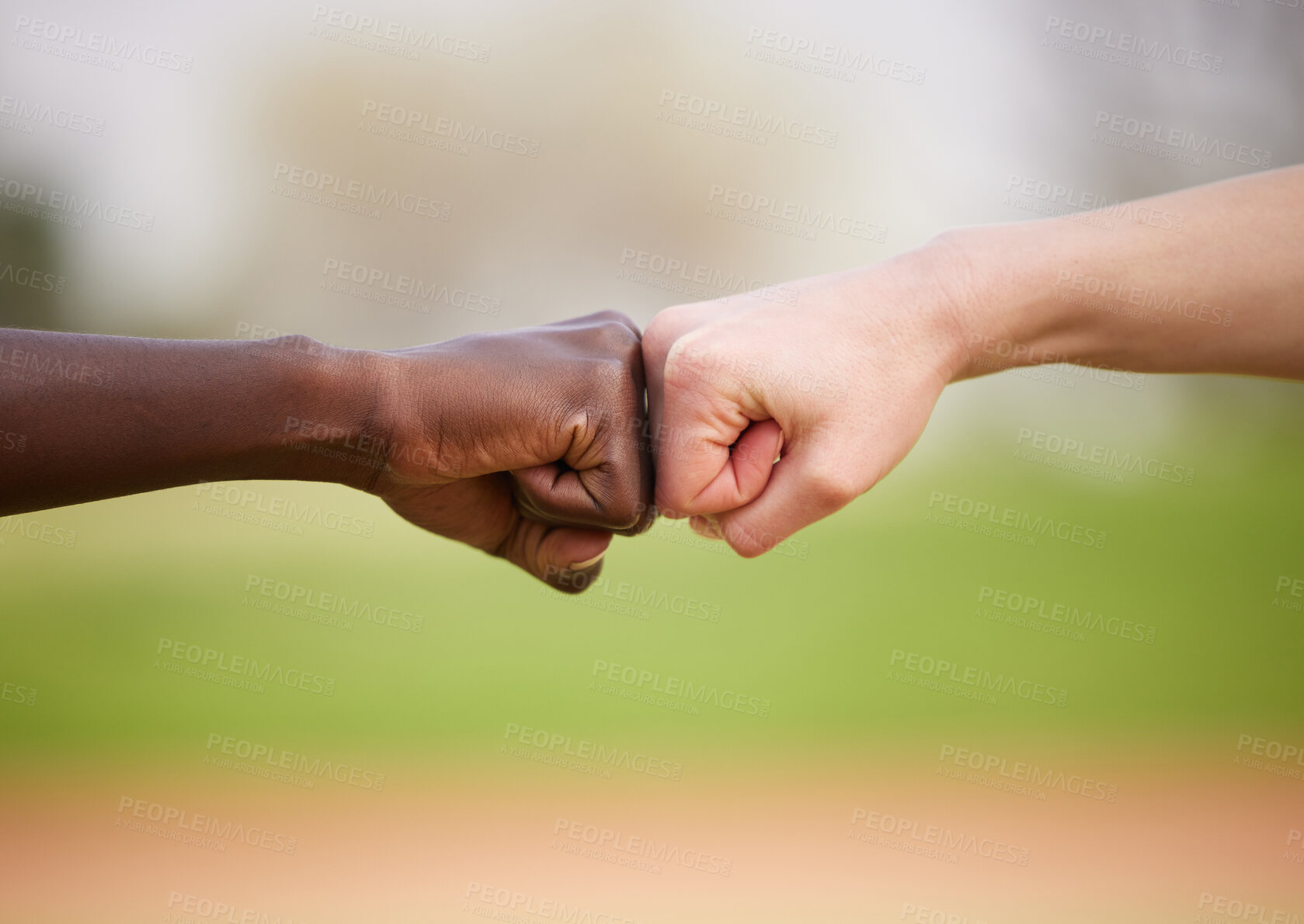 Buy stock photo Diversity, solidarity and people in fist bump for outdoor support, trust and fitness achievement. Teamwork, respect and athlete hands together for sports community, huddle and track competition.