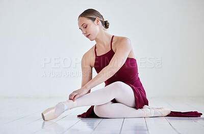 Buy stock photo Woman, ballet and tie laces in studio for dance, artist and getting ready to practice at rehearsal. Female person, dancer and floor for preparation, theatre training and creative artistic performer