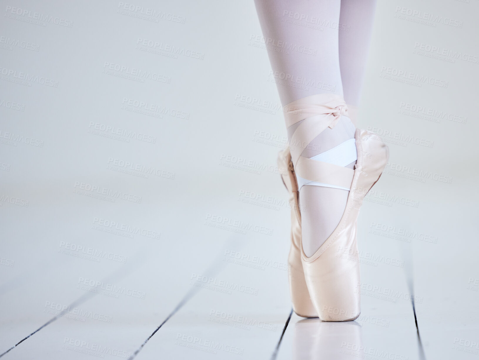 Buy stock photo Woman, ballet and performance feet in studio, learning dance and practice rehearsal on pointe. Person, dancer legs and mockup space for strong balance, theatre training and creative artistic movement