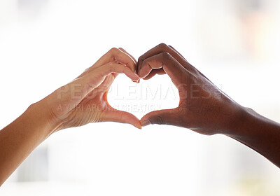 Buy stock photo Interracial couple, heart hands and emoji with love for care, like or support in trust or inclusion at home. Closeup, people and sign with romance for partnership, commitment or health and wellness