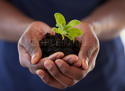 Buy stock photo Shot of an unrecognisable man holding a plant growing out of soil