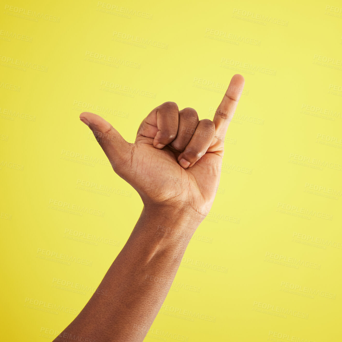 Buy stock photo Hand, gesture and shaka with person in studio on yellow background feeling carefree closeup. Emoji, sign and signal with African model greeting, cheer or winning surfing for good news or victory