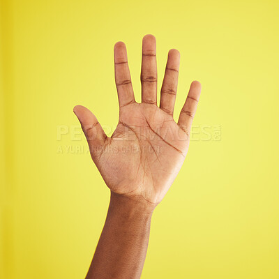 Buy stock photo Studio shot of an unrecognisable man waving against a yellow background