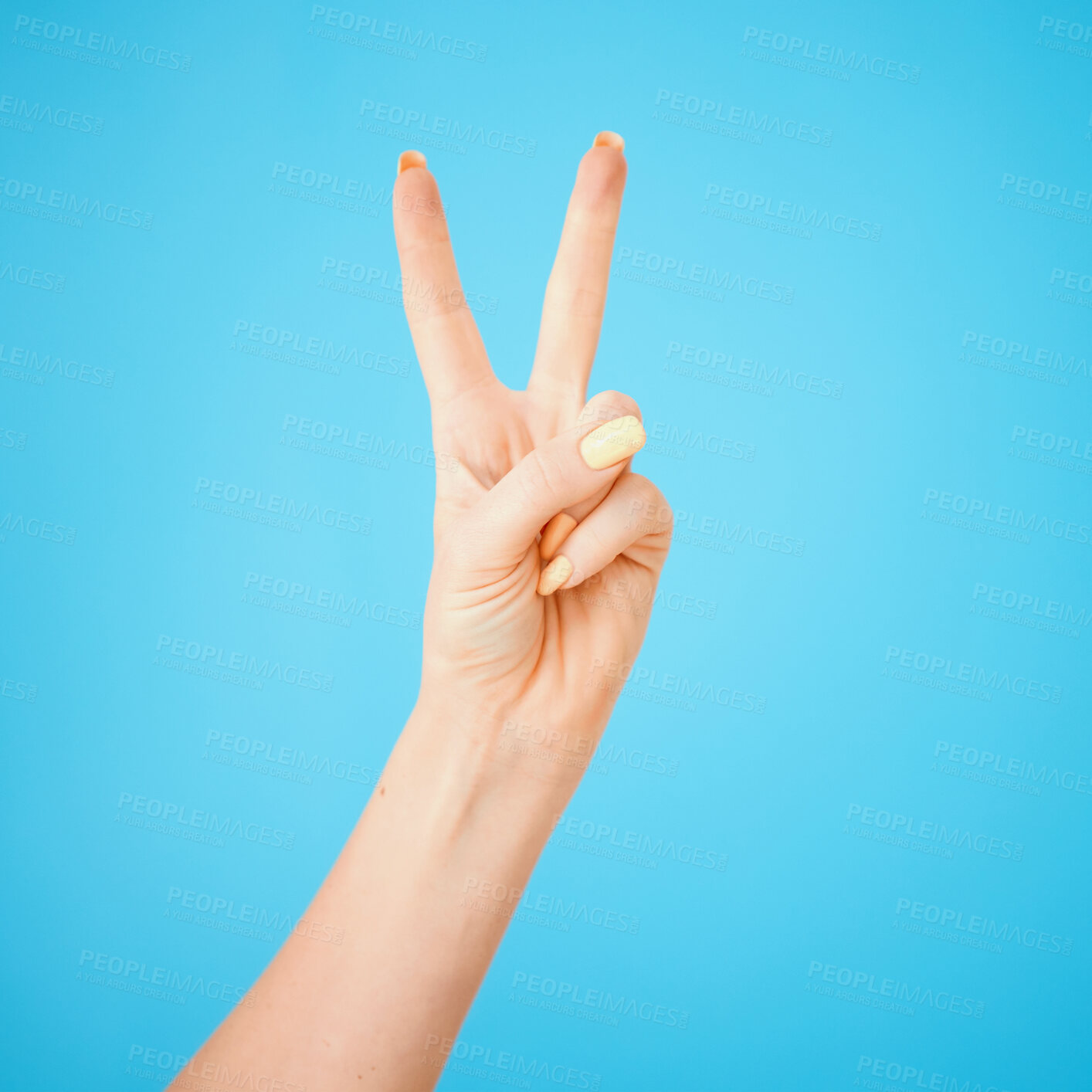 Buy stock photo Opinion, model and hand with peace, sign and support with agreement, respect and review on blue studio background. Person, mockup and closeup fingers for feedback, vote and emoji with icon and like