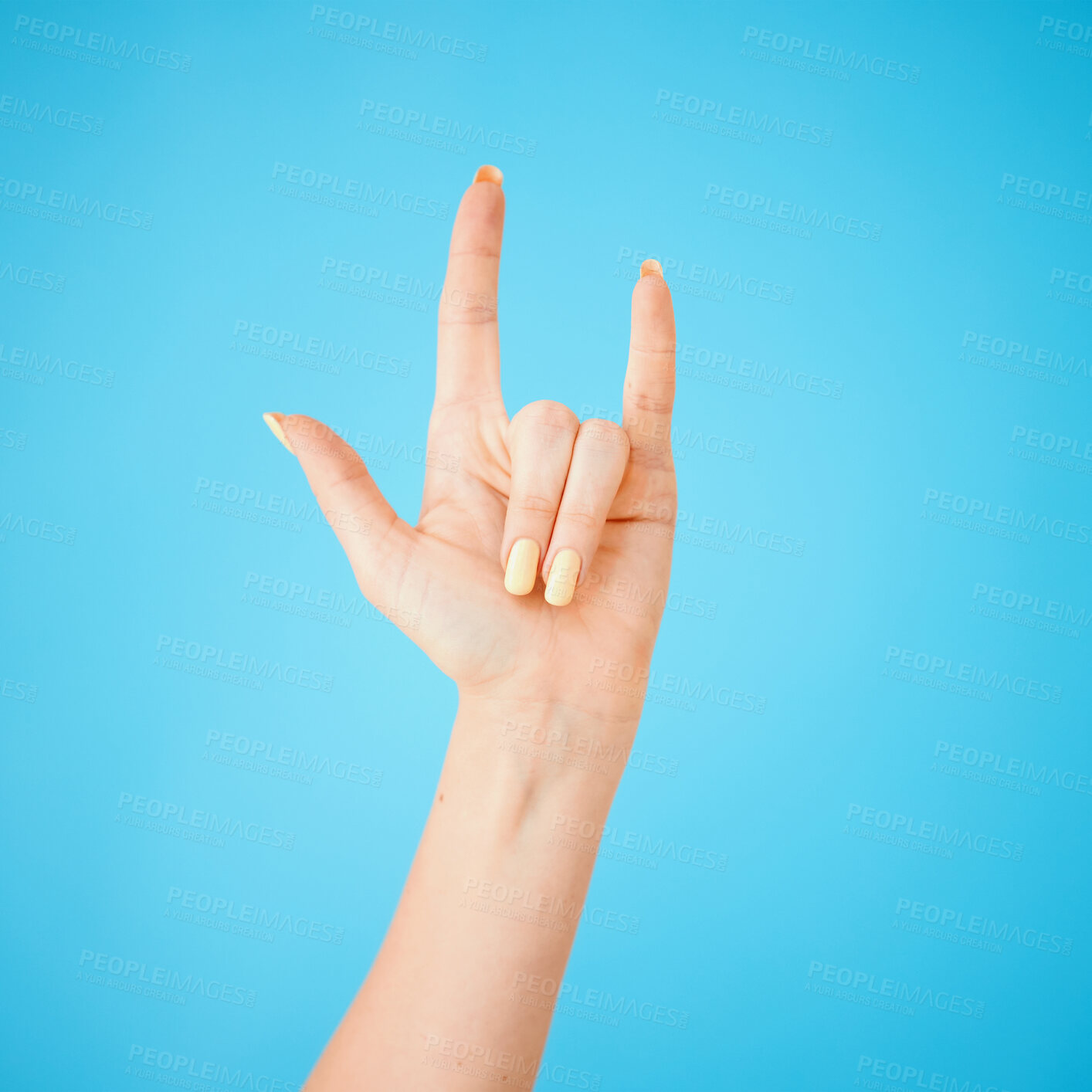 Buy stock photo Person, hand and rock gesture with sign in studio for grunge, rockstar or devil horns on blue background. Crazy, aesthetic and model for metal emoji, punk icon or rebel symbol on mockup space