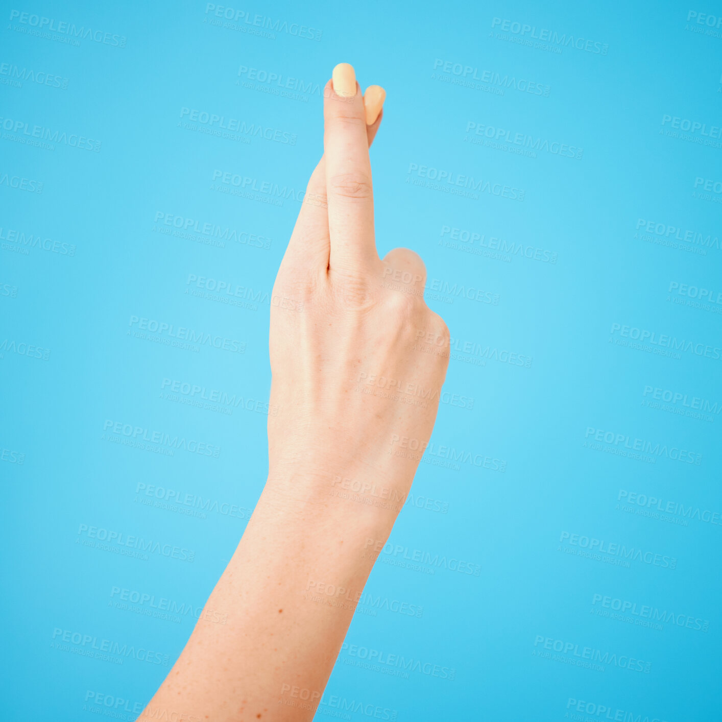 Buy stock photo Excited, hope and person with fingers crossed isolated on blue studio background. Happy, trust and model with wish, waiting and sign with hand gesture for winning or future achievement or luck emoji