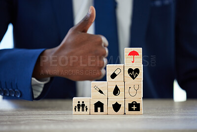 Buy stock photo Hands, building blocks and sign for insurance in office with protection for assets, health or thumbs up. Person, agent and wood toys with yes, like and icon for risk cover for real estate at company