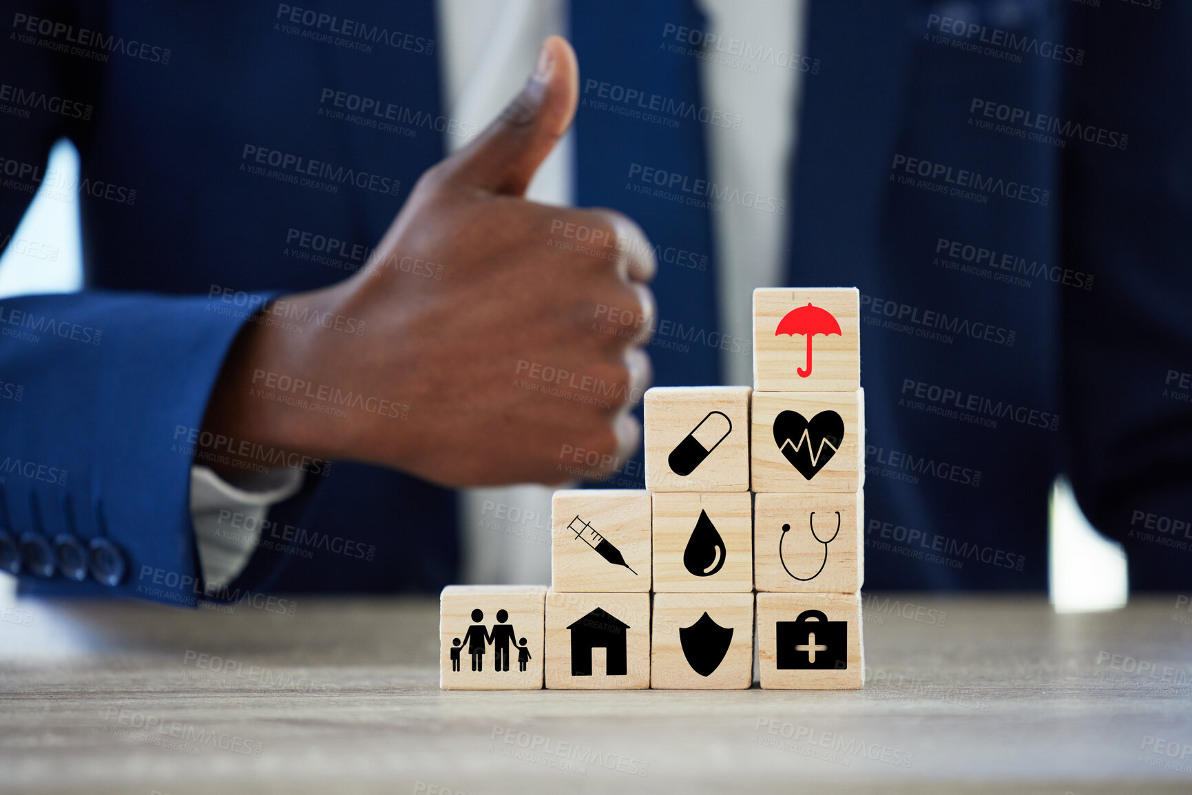 Buy stock photo Hands, building blocks and sign for insurance in office with protection for assets, health or thumbs up. Person, agent and wood toys with yes, like and icon for risk cover for real estate at company