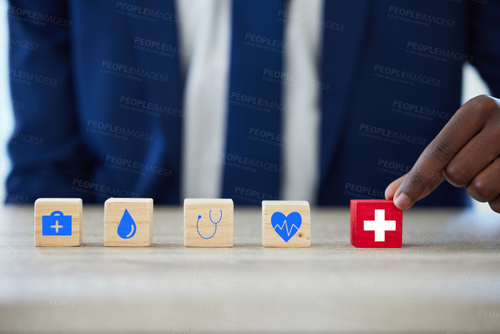 Buy stock photo Hand, building blocks and security with insurance for health in office, protection or solution for puzzle. Person, agent and wood toys with cross, cardiology or icon for risk cover service at company